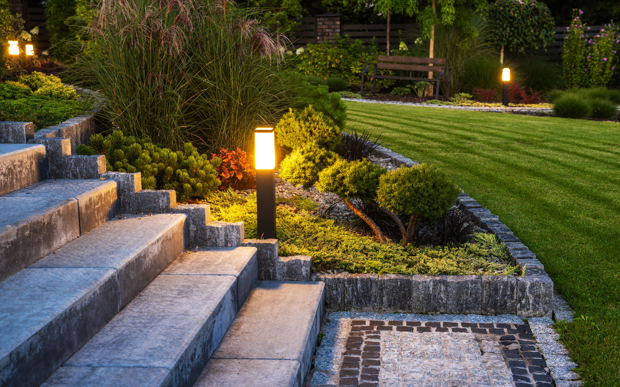Finished landscape steps, retaining walls, planting, and outdoor lighting from the Atlas portfolio