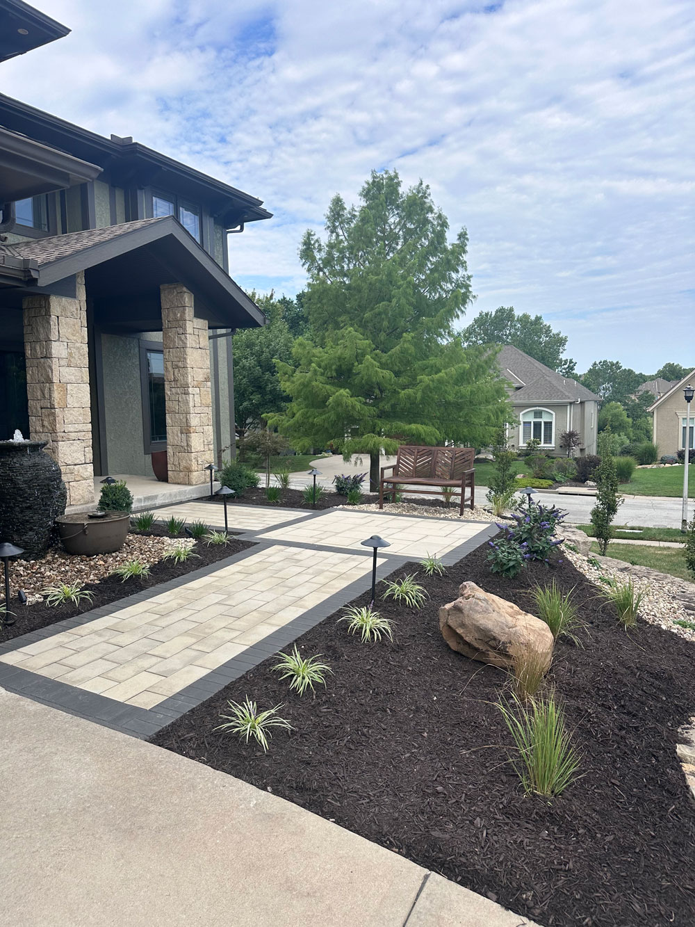 Front entry planting beds finished with dark natural mulch and clean edges